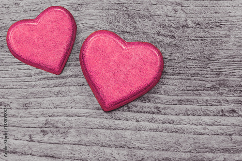 Couple red heart chocolates on wooden background