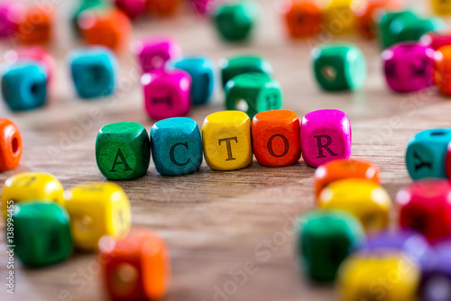 Foto actor - word created with colored wooden cubes on desk.