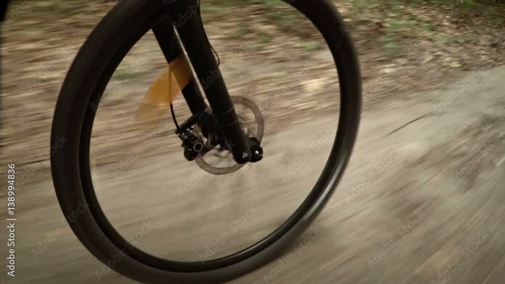 Mountain Bike Wheel Rolling over Country Road Mountain Bike Wheel Rolling over Country Road