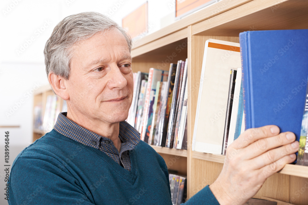 Fototapeta premium Mature Male Student Studying In Library