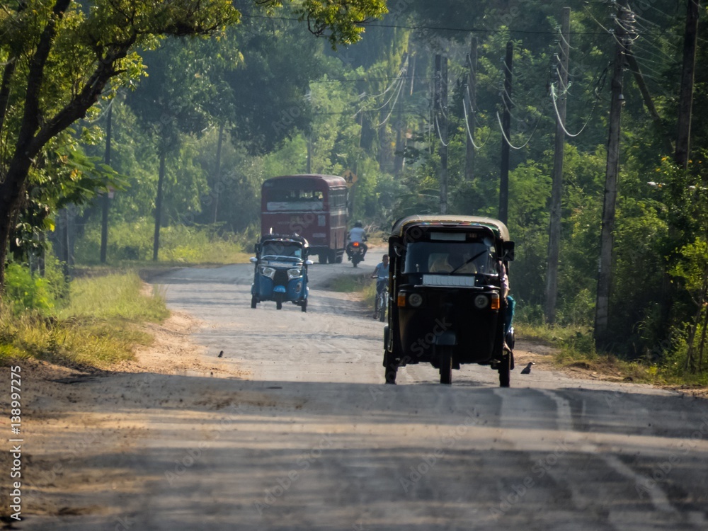 Rural road in the morning with vehicles in Sri Lanka