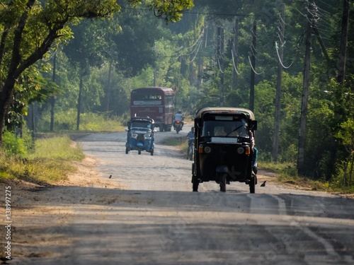 Rural road in the morning with vehicles in Sri Lanka