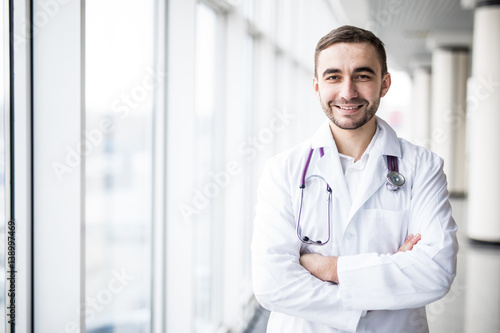 Portrait of attractive young doctor in clinic hall