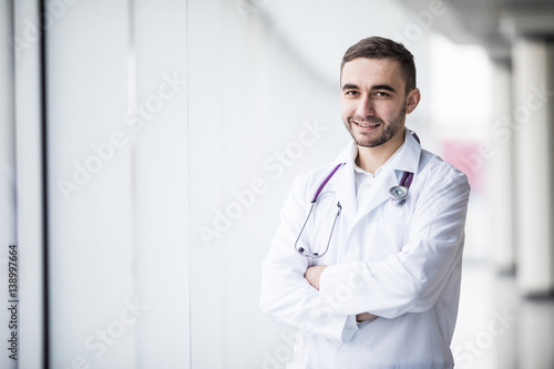 Portrait of attractive young doctor in clinic hall
