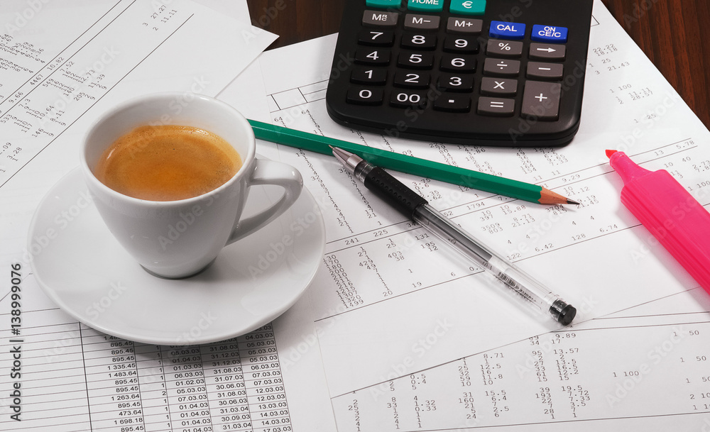 Calculator, papers, pen, pencil and cup of coffee on the table Calculator, papers, pen, pencil and cup of coffee on the table