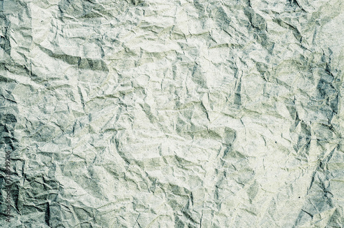 Green tone crumpled paper abstract background