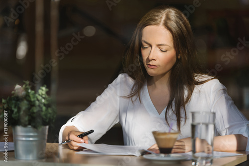 Accountant analyzing reports in a coffee shop