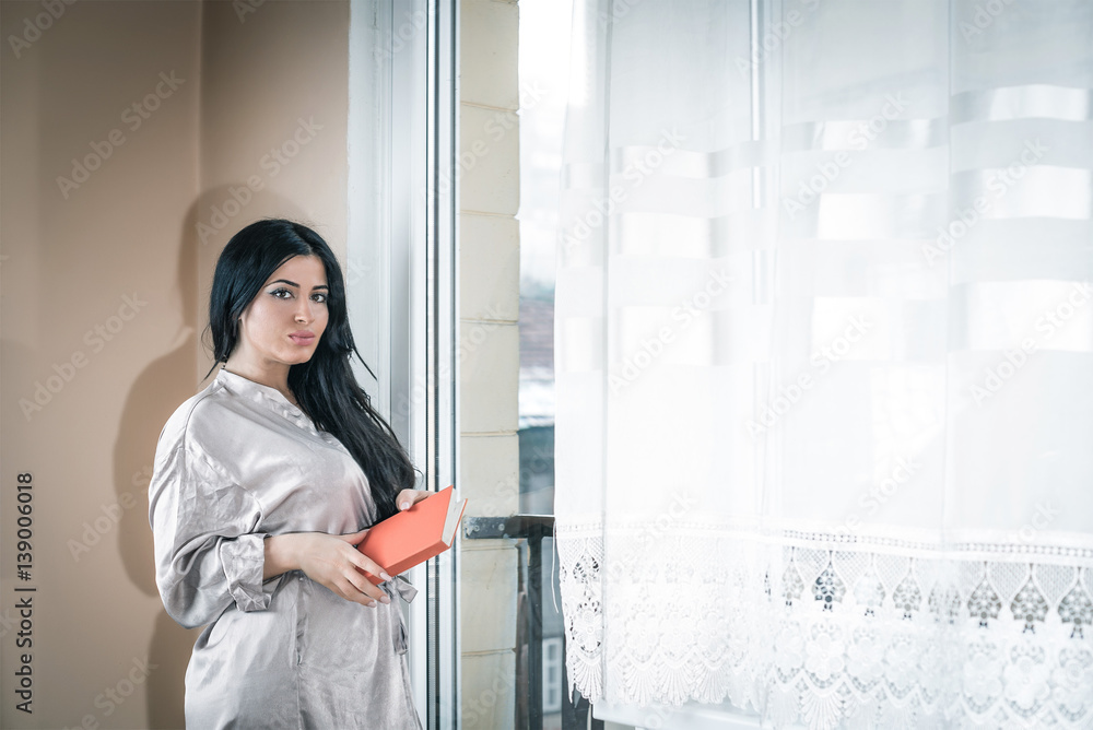 Elegant girl reading a book in apartment Elegant girl reading a book in apartment