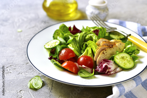 Fresh green salad with grilled chicken.