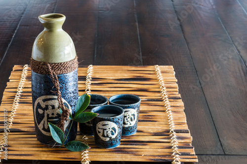 Japanese sake set on the bamboo mat.