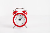 Red little alarm clock on white background