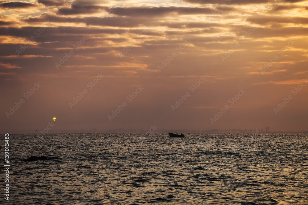 Morning fishing. Boat at sunset. Fisherman