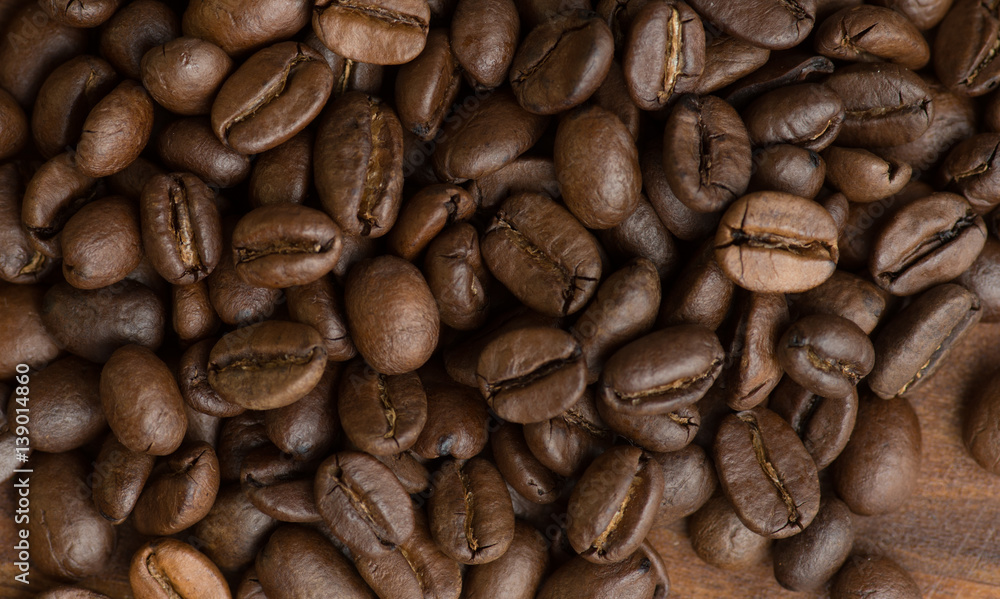 Brown coffee beans, closeup macro for background and texture Brown coffee beans, closeup macro for background and texture