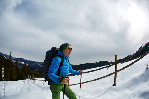 hiker with backpack on the trail in the Carpathians mountains at winter © vitaliymateha