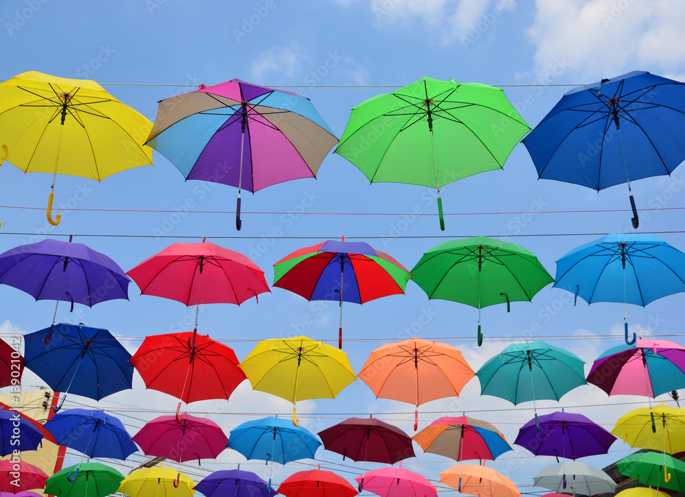 Obraz premium Colorful umbrellas background. Coloruful umbrellas urban street decoration.