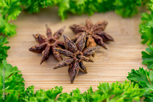 Star anise and Parsley on wood