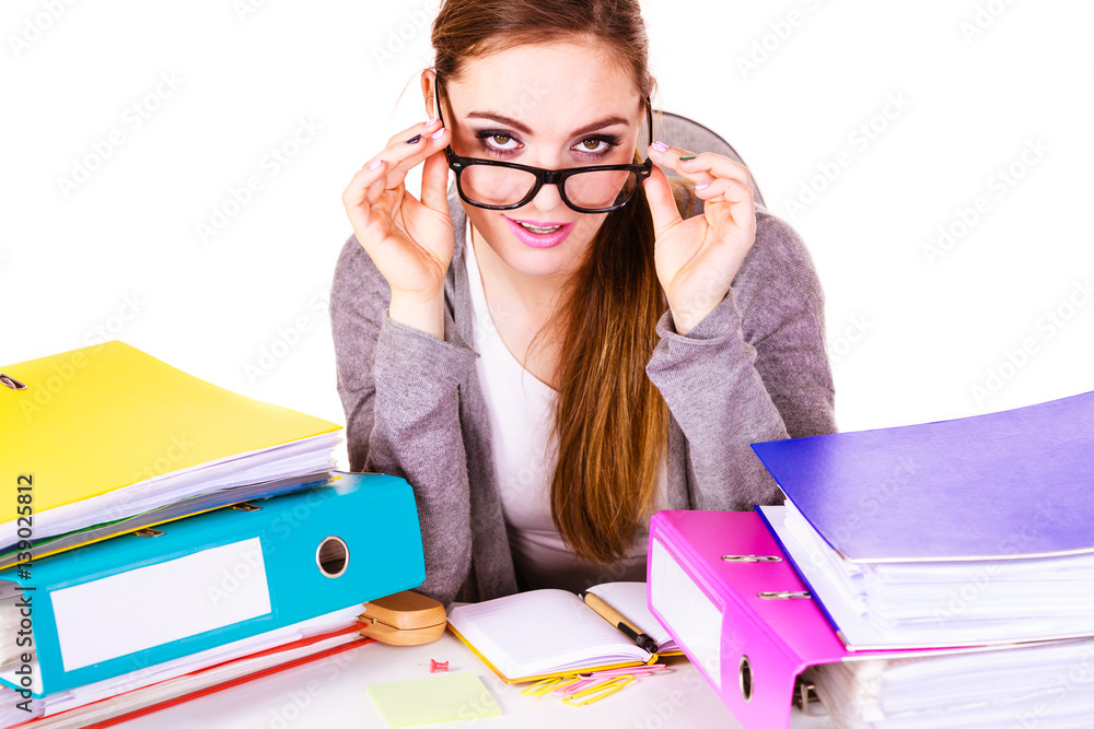 Woman sitting at desk in office working Woman sitting at desk in office working