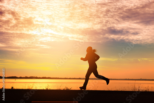 Fototapeta Naklejka Na Ścianę i Meble -  Silhouette man relaxing by running