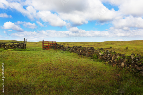 Open red gate of stone wall corral at South Point of Big Island, Hawaii