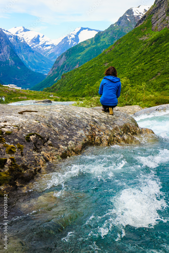 Tourist woman by Videfossen Waterfall in Norway