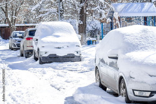 car in the snow after a snowfall in town