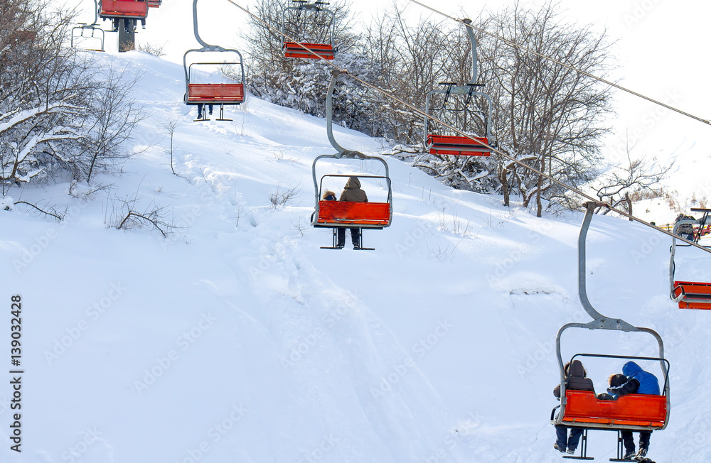 skiers on a lift