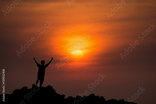 silhouette man Happy celebrating winning success at sunset