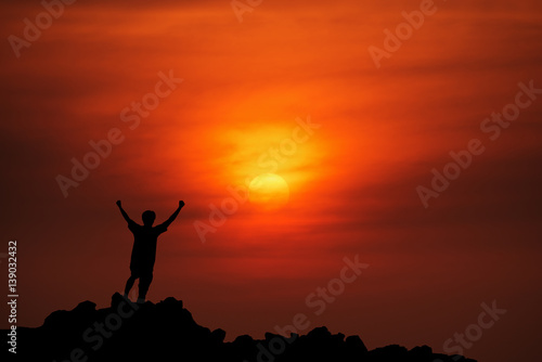 silhouette man Happy celebrating winning success at sunset