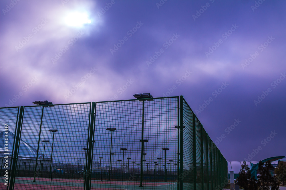 Lanterns light in cloudy weather on the tennis court