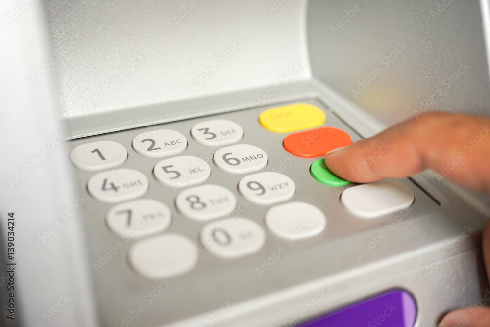 Asian BusinessMan hand is entering number on ATM machine to deposit / withdraw money, Financial Banking Technology Automatic machine Transfers background concept Asian BusinessMan hand is entering number on ATM machine to deposit / withdraw money, Financial Banking Technology Automatic machine Transfers background concept