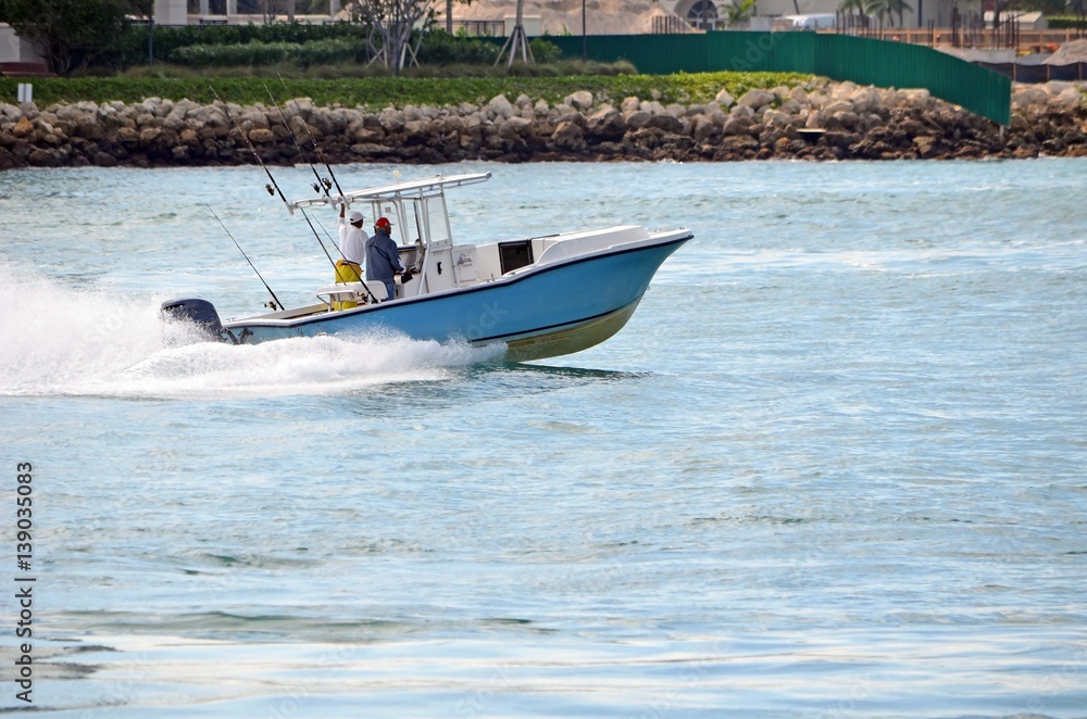 Obraz premium Two fishermen heading back from the sea after a morning of sport fishing in southeast florida