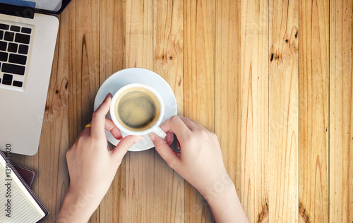  Female hands and coffee, Office Supplies with Workspace on wood table, Above view.