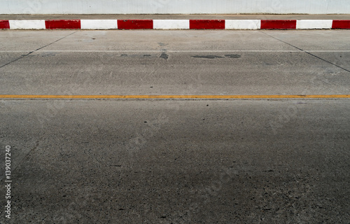 Red and white concrete road curb