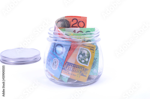 Saving Australian dollars in a glass jar