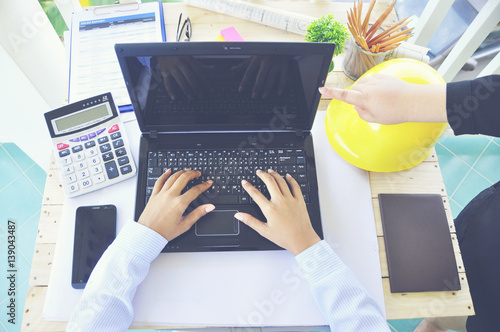 Wallpaper Mural A young Asian  Architect drawing on architectural project business, architecture, building, construction and people concept - close up of architect hands with blueprint ,Yellow helmet Torontodigital.ca