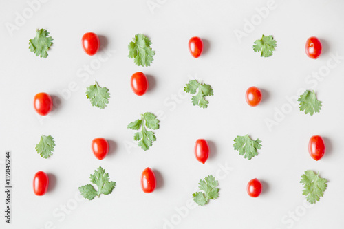 Pattern of vegetables - tomatoes and parsley  herbs  flat shot  top view