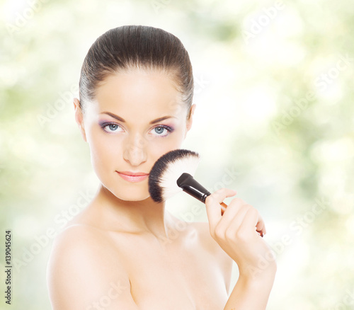 Portrait of young, beautiful and healthy woman: over spring and summer background. Healthcare, spa, makeup and face lifting concept.