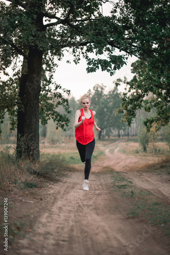 Young woman jogging at park © dashamuller