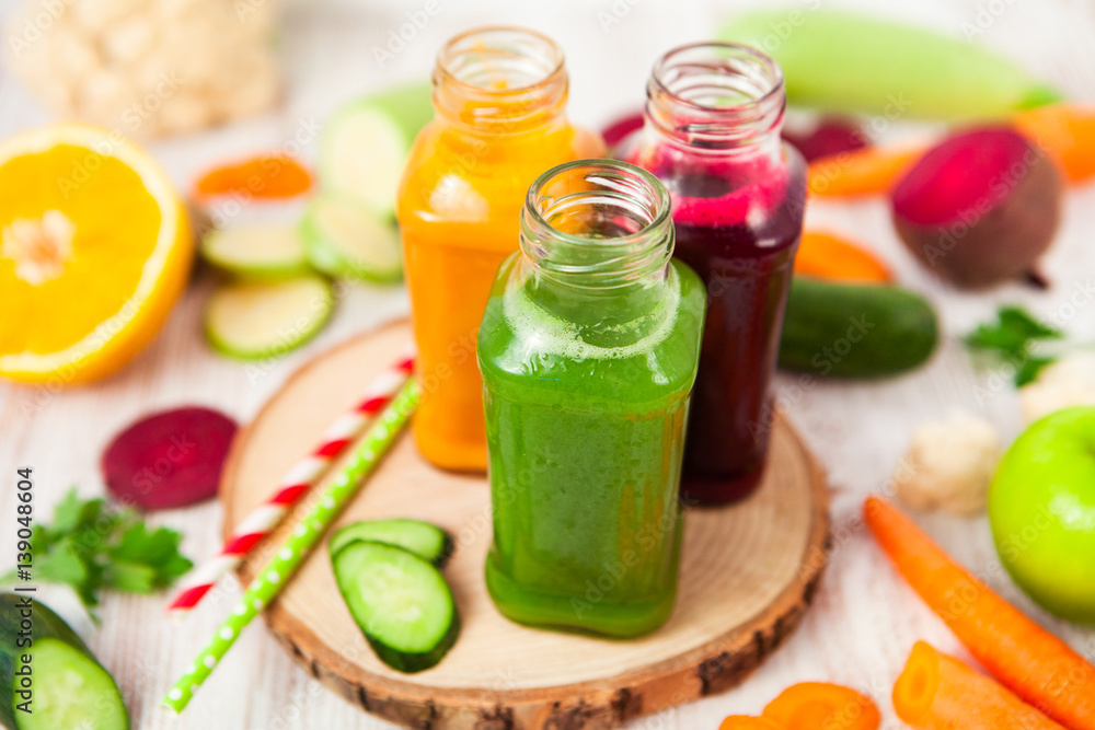 Freshly squeezed vegetable juice in bottles, useful vitamin cocktail, detox diet, selective focus