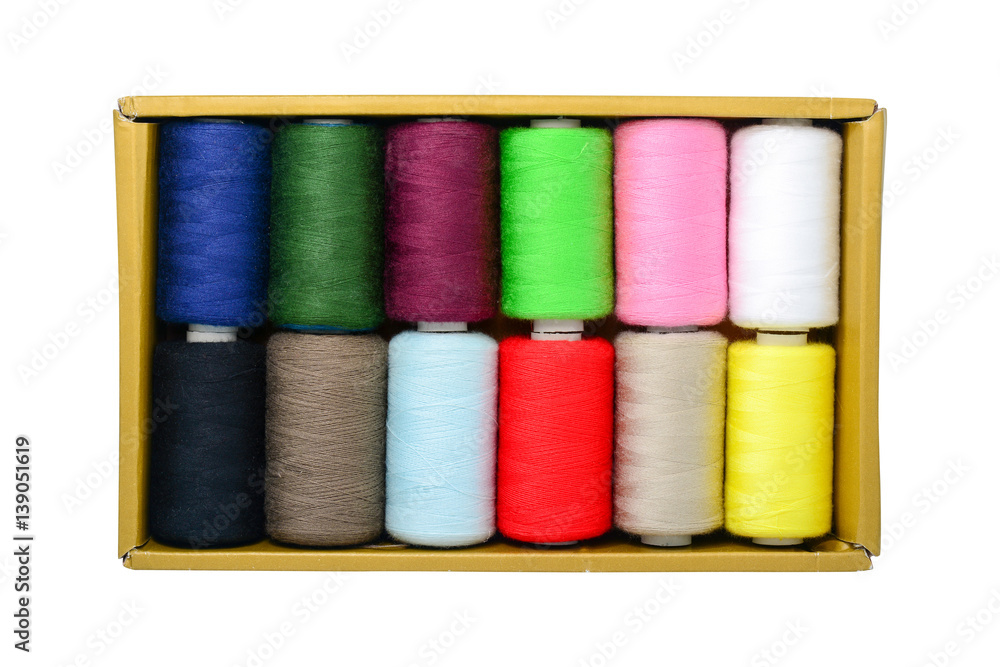 Spools of thread in box isolated on white Spools of thread in box isolated on white