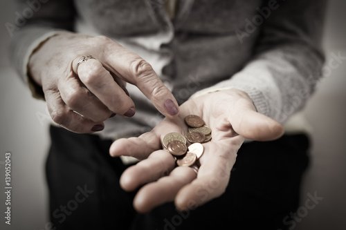 Older person counting money in her palm