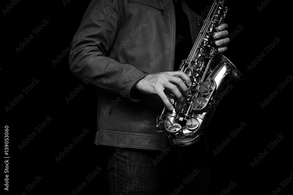 Obraz premium Jazz saxophone player in a brown leather jacket.