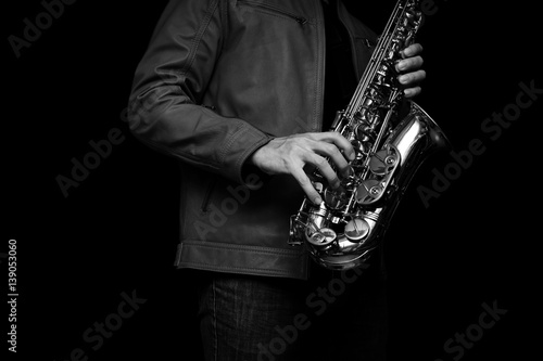 Jazz saxophone player in a brown leather jacket.