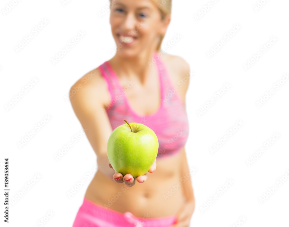 Healthy woman standing with apple in her hand Healthy woman standing with apple in her hand