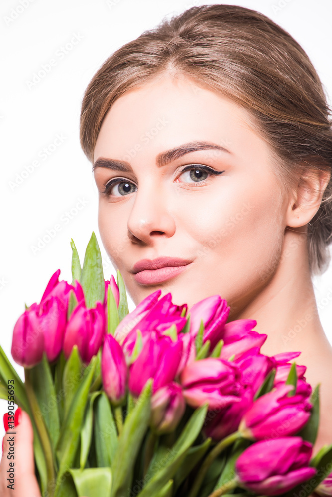 Closeup portrait of pretty women holding bouquet of tulips Closeup portrait of pretty women holding bouquet of tulips