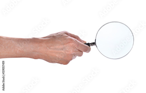 man hand holding magnifying glass isolated on white background