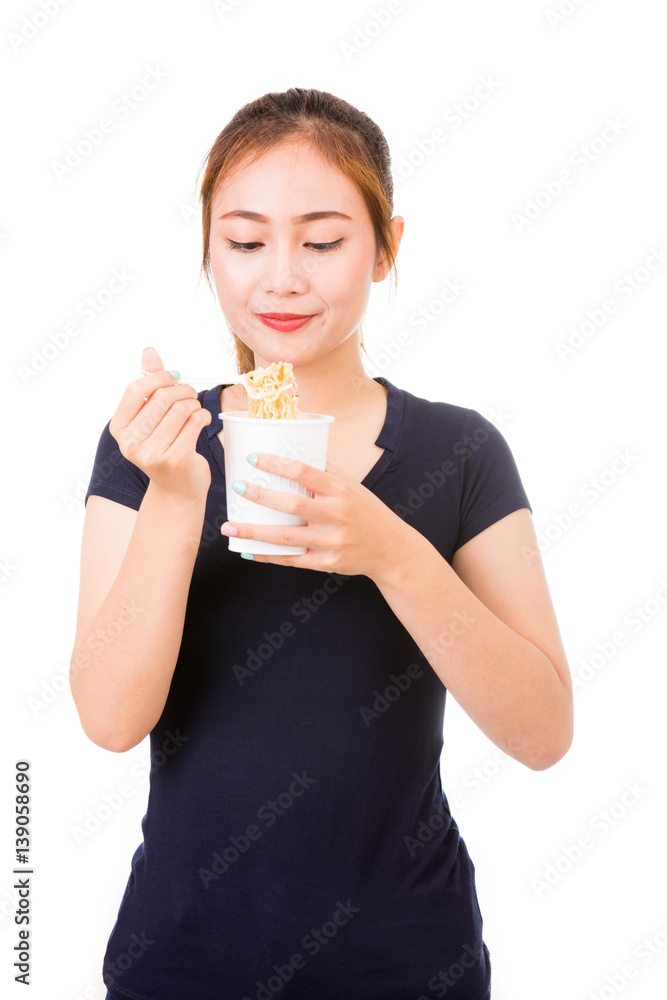 Young beautiful asian girl eating instant noodle using plastic fork. Young beautiful asian girl eating instant noodle using plastic fork.