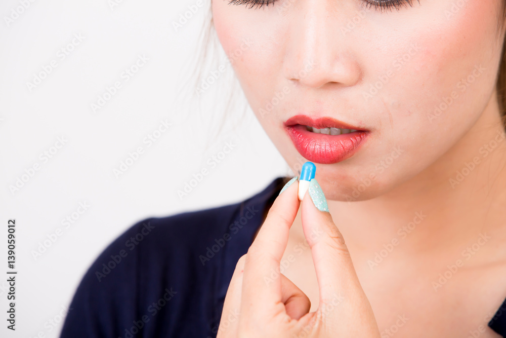 Young woman taking pill or drug health and medicine concepts, isolated on white background Young woman taking pill or drug health and medicine concepts, isolated on white background