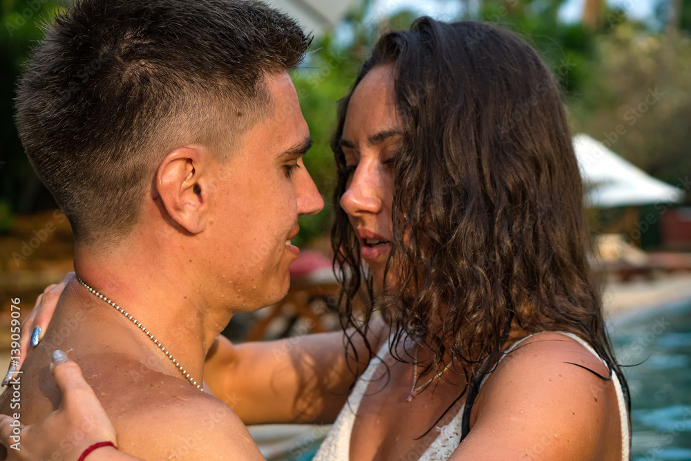 Young smiling couple relaxing in the pool
Young smiling couple relaxing in the pool