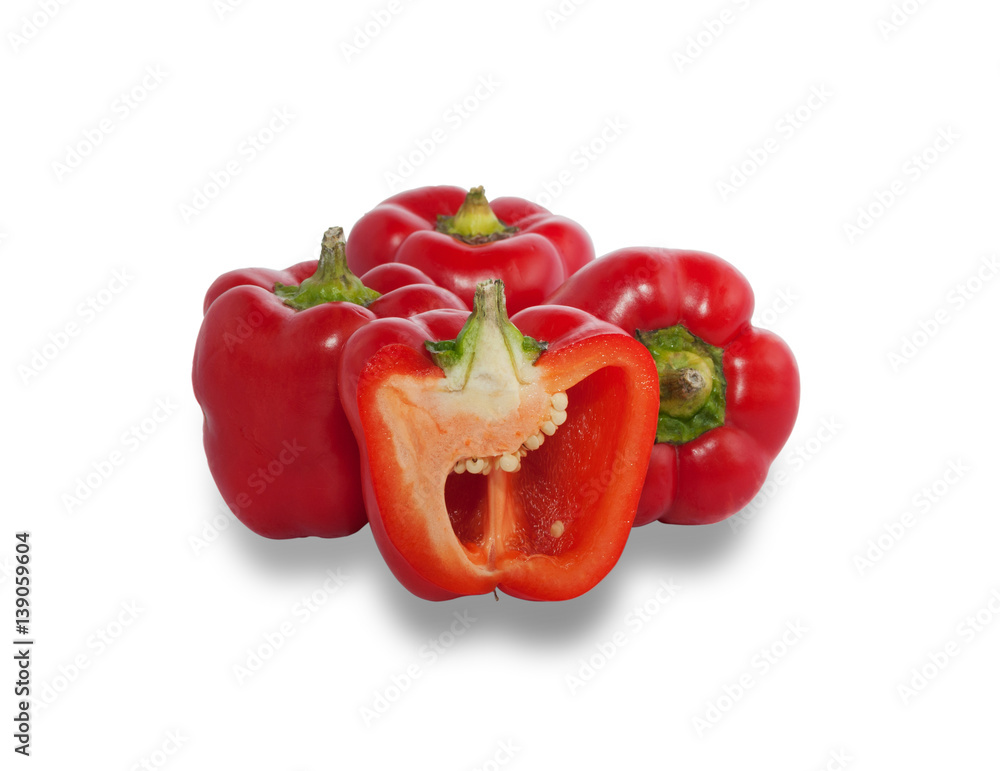 Several ripe red peppers, one of which is cut in half Several ripe red peppers, one of which is cut in half